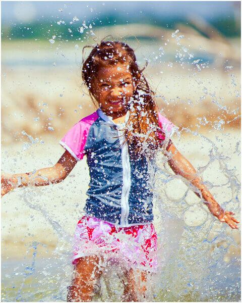 girl splashing in the ocean