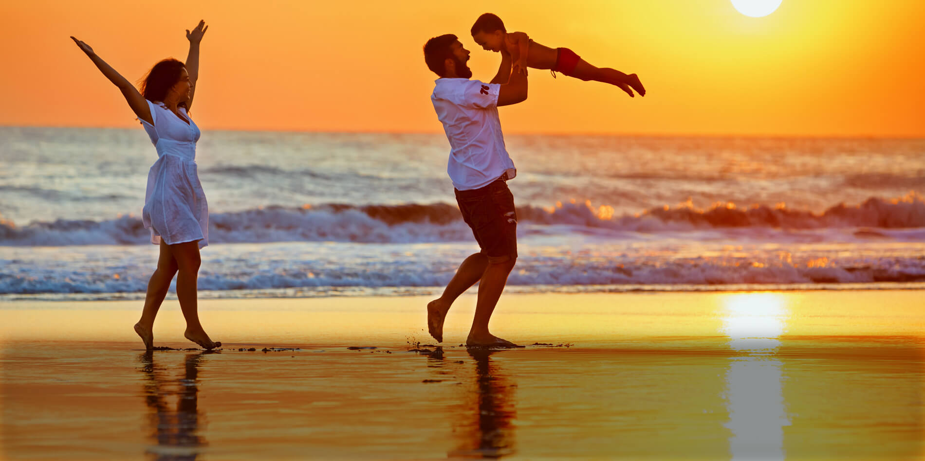 Family on the beach at sunset