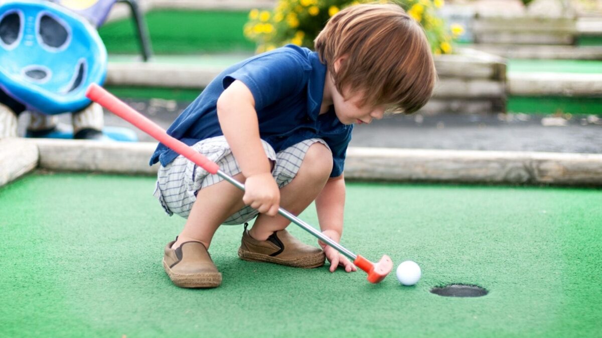 A child playing mini golf in Atlantic Beach Town Park