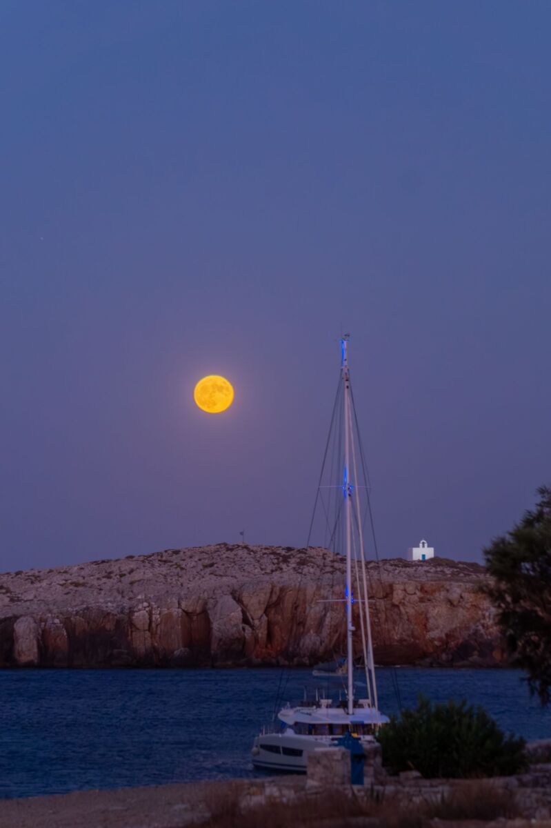 sailboat over moonlighjt