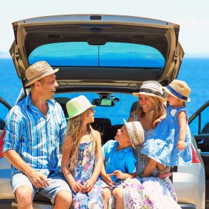 family laughing on a road trip